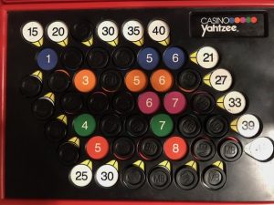 Example board mid-play showing markers covering numbers and some scores