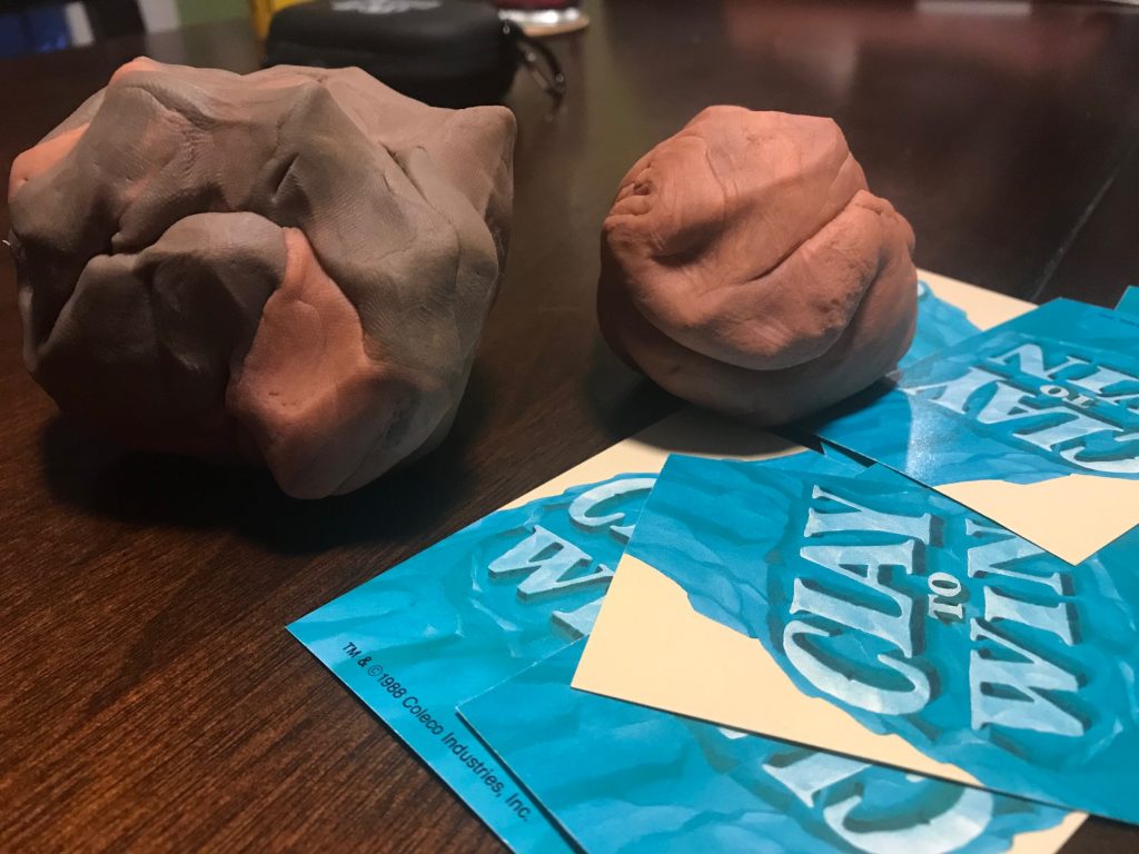 A larger clay ball on the left and smaller clay ball on the right