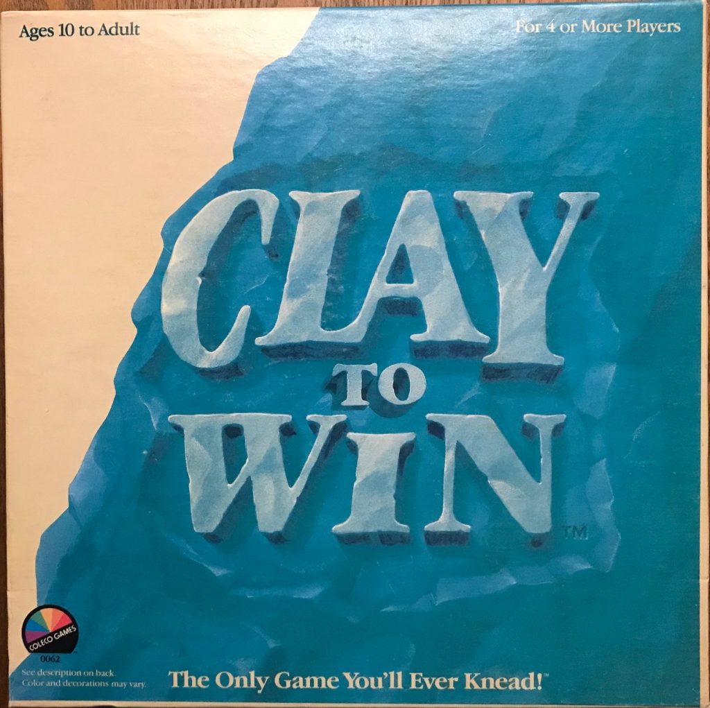 Cover has Clay to Win written in clay in blue