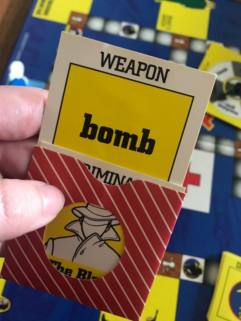 A hand holding the packet with the WEAPON sticking out