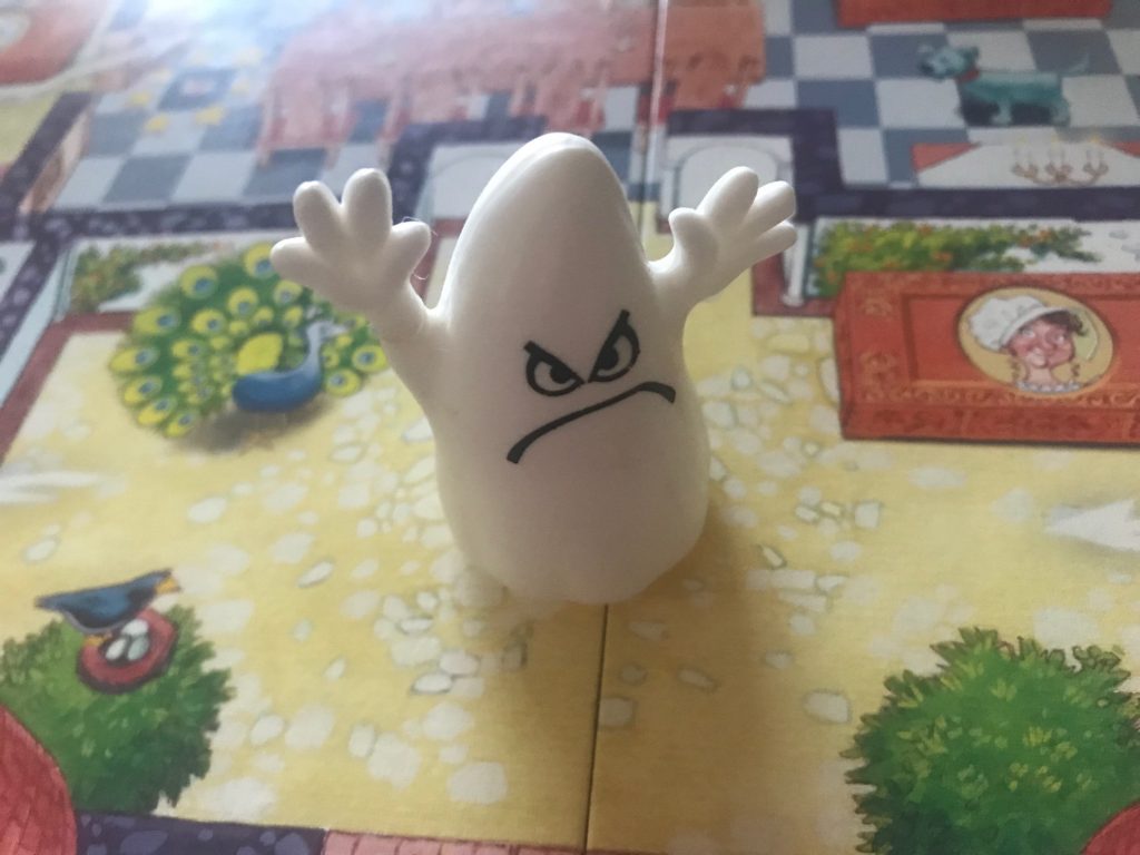 The ghost is sticking his arms up and frowning