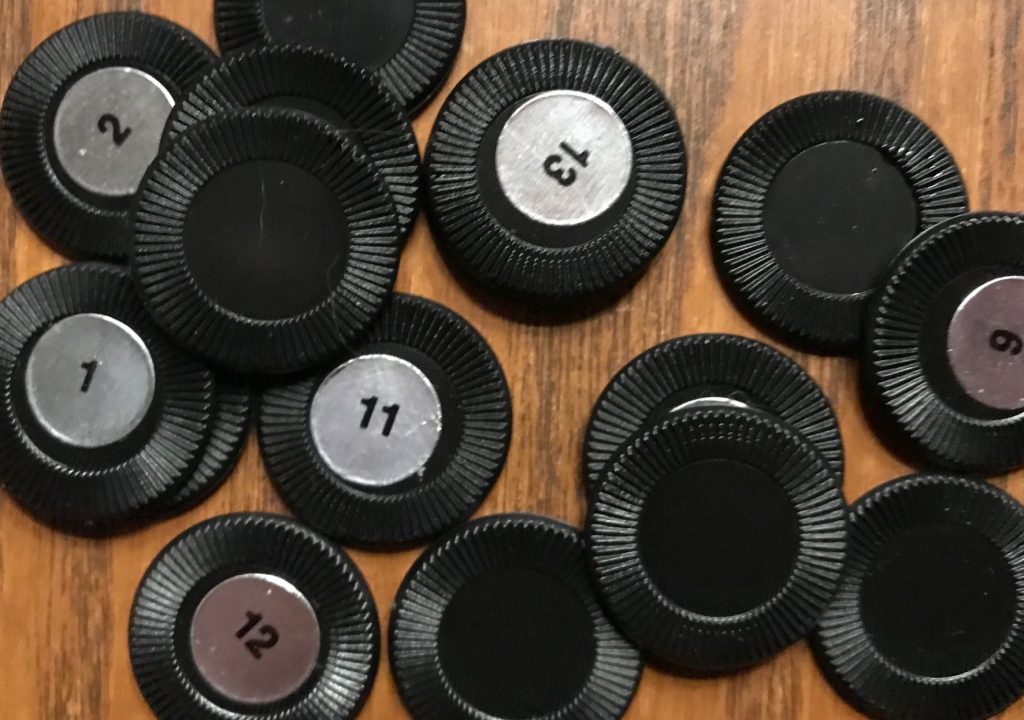 Black chips with silver stickers showing their numbers