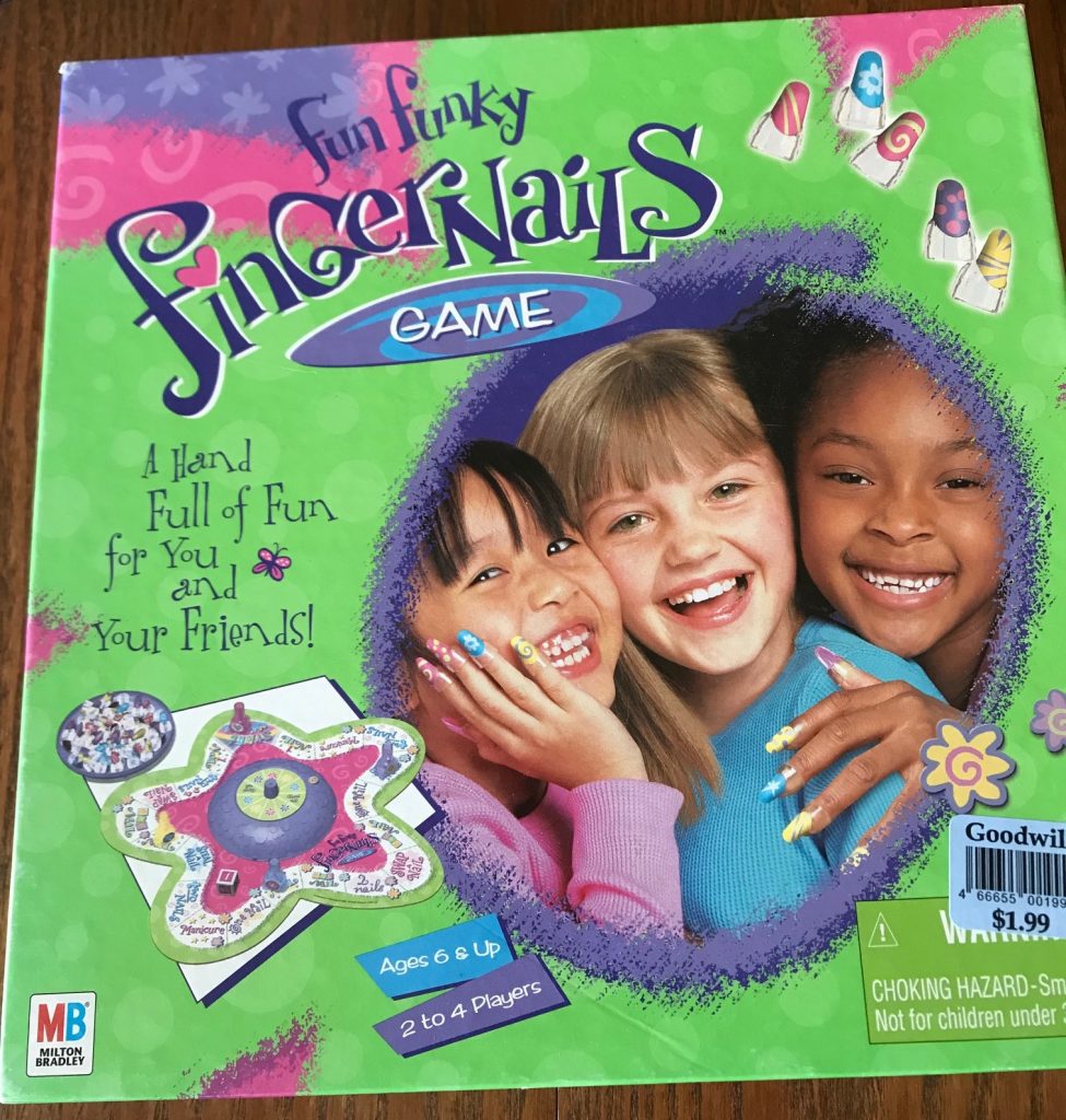 Cover shows 3 young girls wearing fake fingernails and smiling at the camera