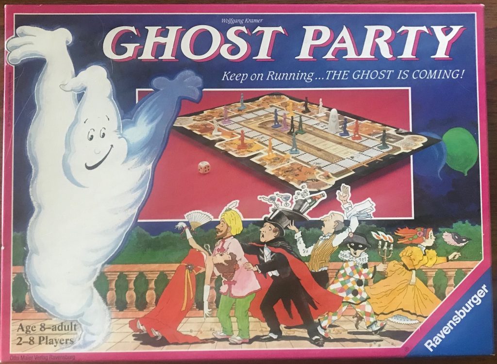 This cover has a ghost with its arms up on the left side, a large image of the board in the upper middle and the cartoon characters in the lower middle