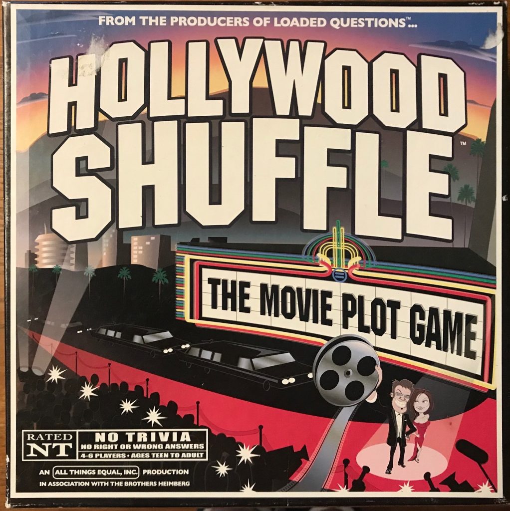 The cover mostly has the text of the game name, but it is over a red carpet with a power couple at the front and the tagline on the marquee