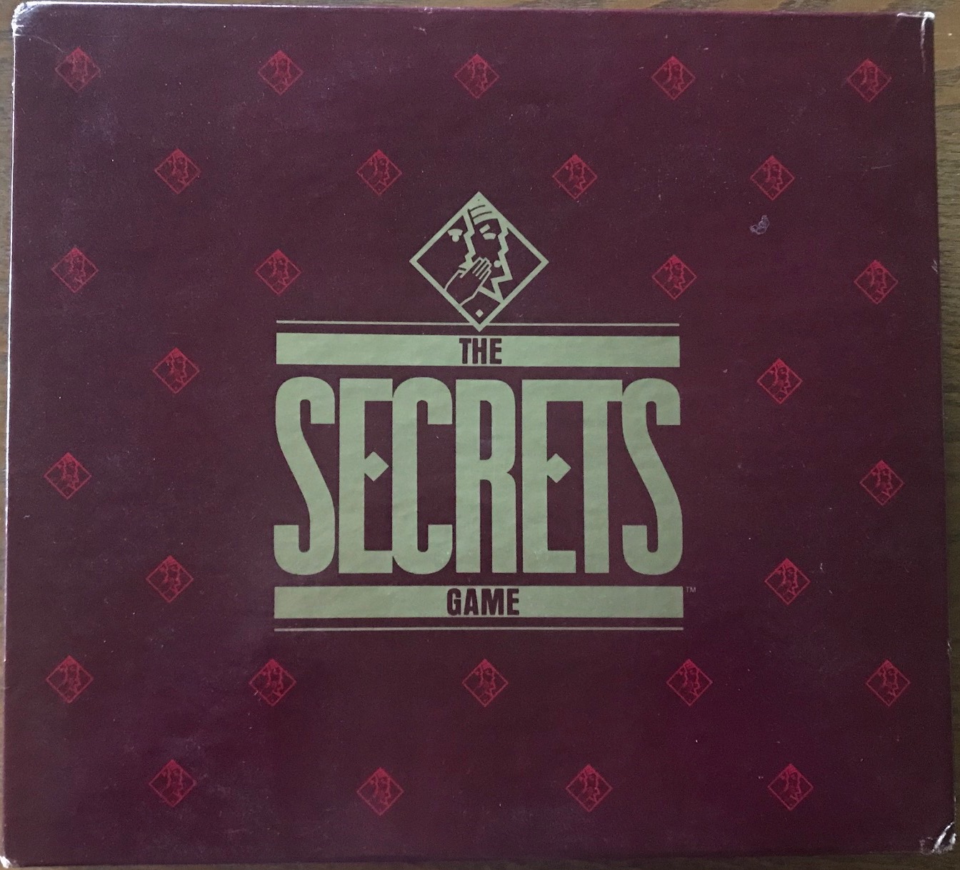 This cover is burgundy with The Secrets Game in gold