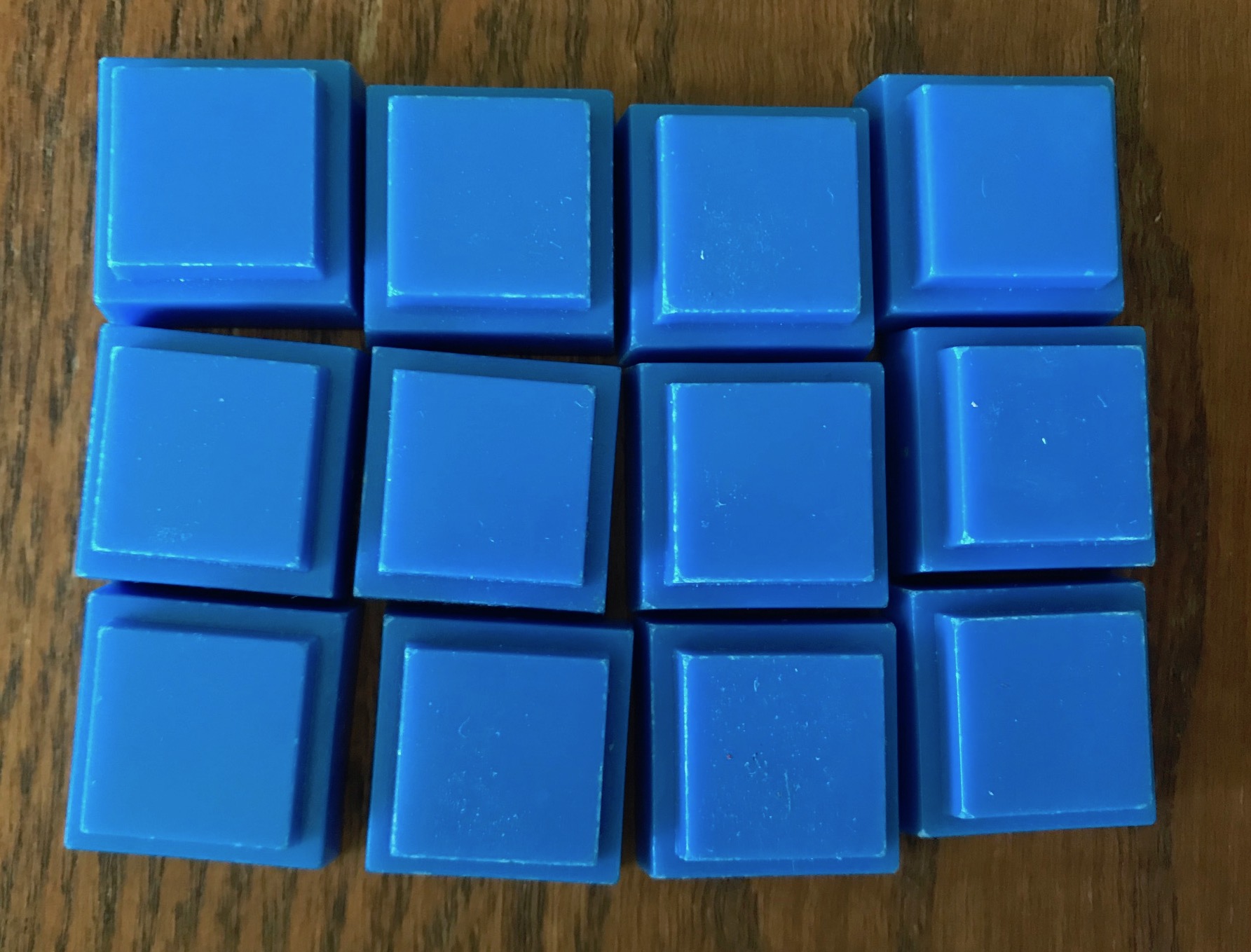 12 blue pieces lined up 3 by 4 to look like a chocolate bar