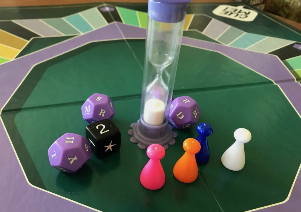 Components including the timer, the pawns, one number die and the four letter dice