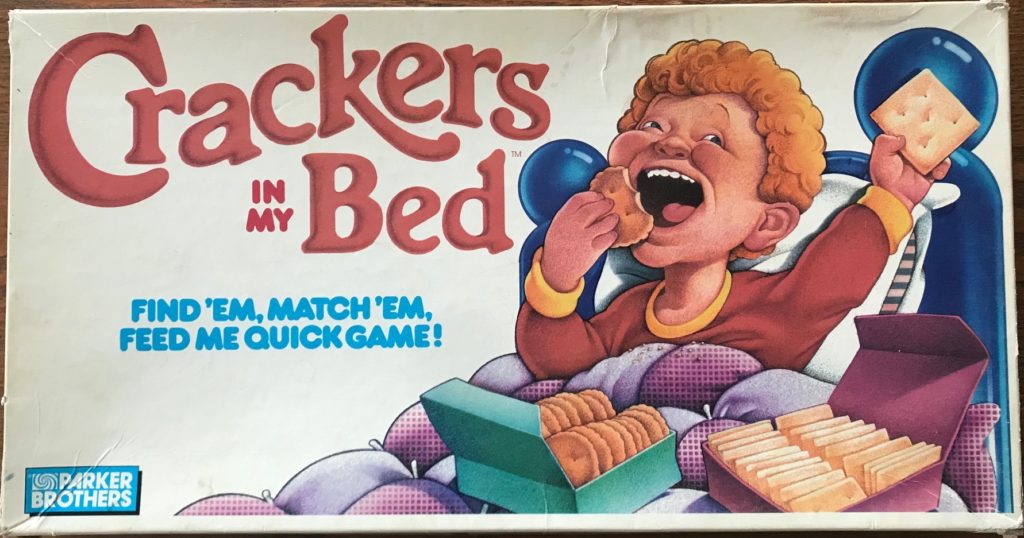 A boy eating crackers in his bed