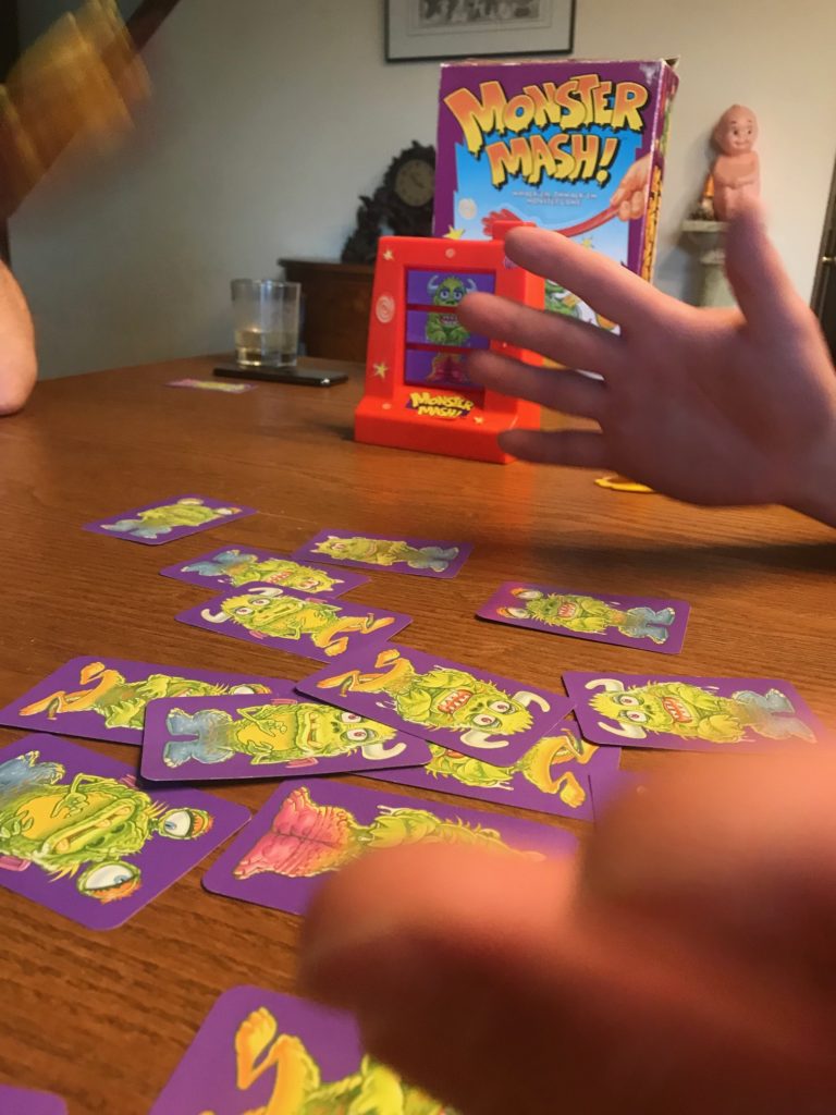 Hands gesturing wildly over monster cards