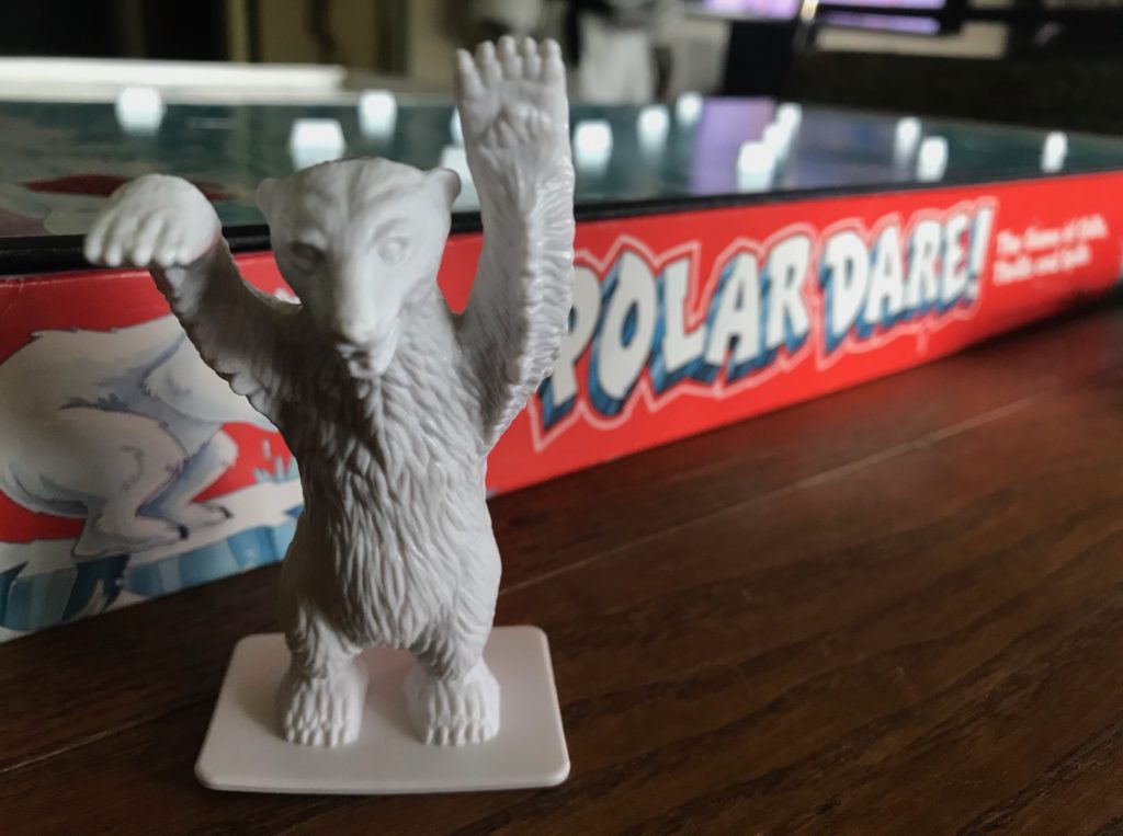 The polar bear has his hands in the air very menacing