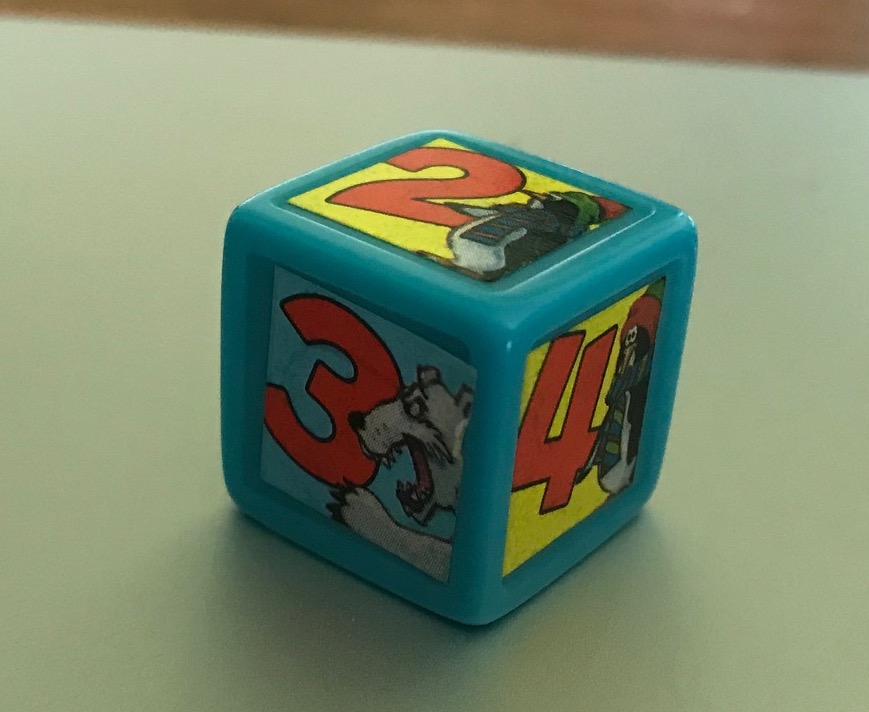 The die has either a penguin or polar bear next to a number and my photo has poor lighting